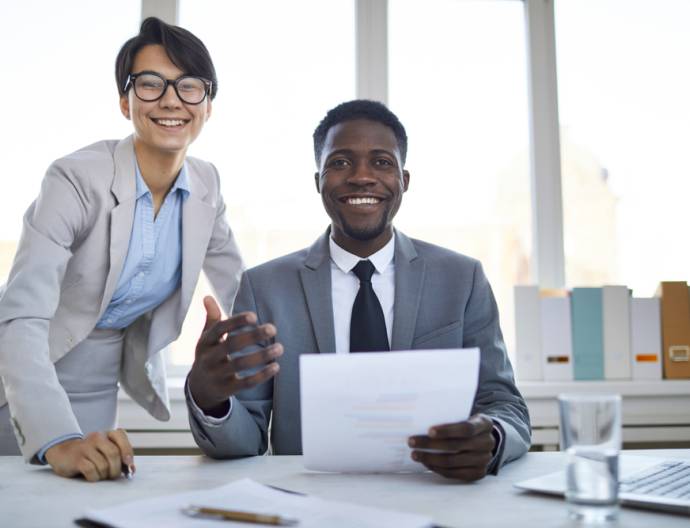 Two,Young,Happy,Colleagues,In,Formalwear,Looking,At,You,With